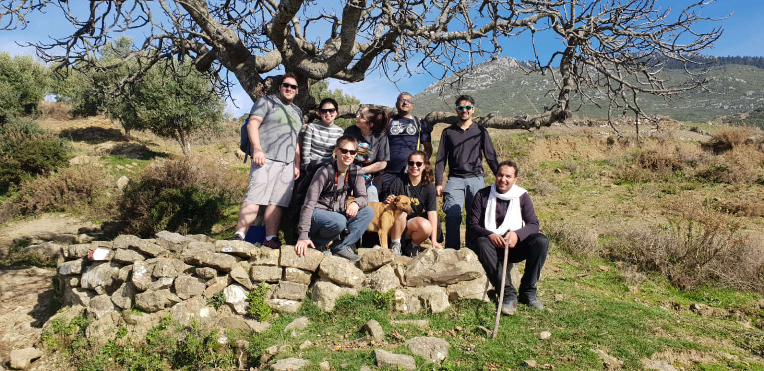 A person holding a cane with their family.