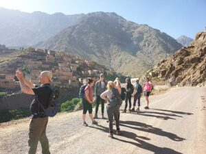 a group of tourists standing on a road 