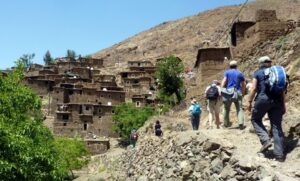 people trekking on the side of mountains 