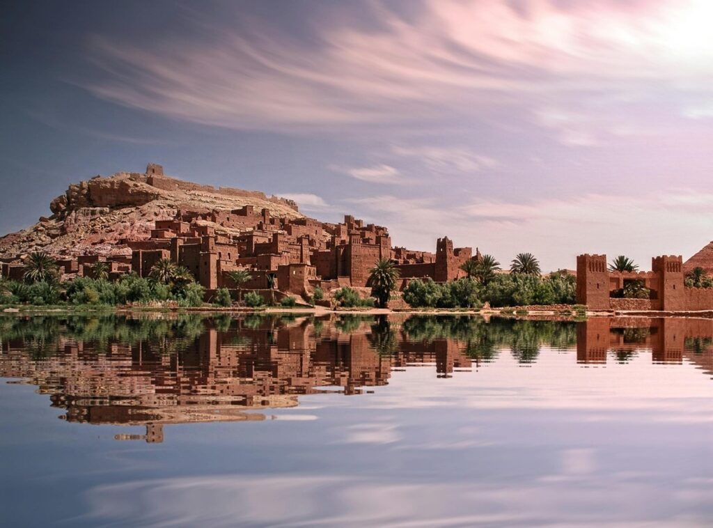 a picture of a beautiful landscape with lakes and buildings