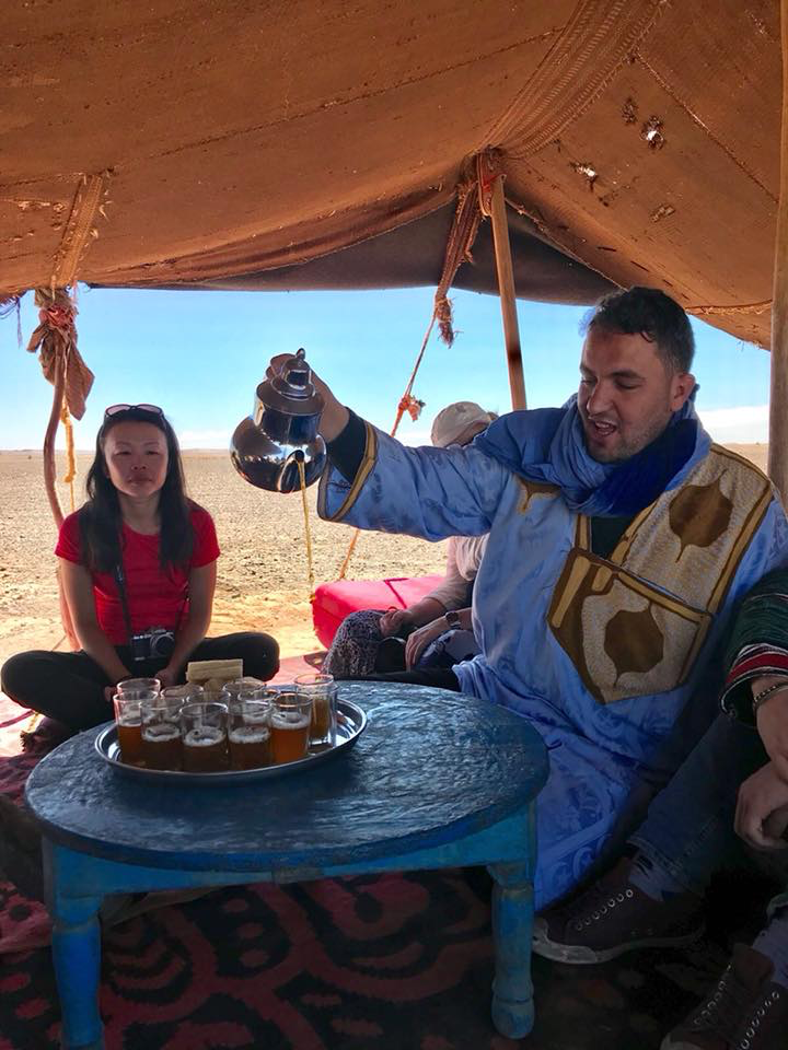 Omar graciously pouring traditional Moroccan mint tea.