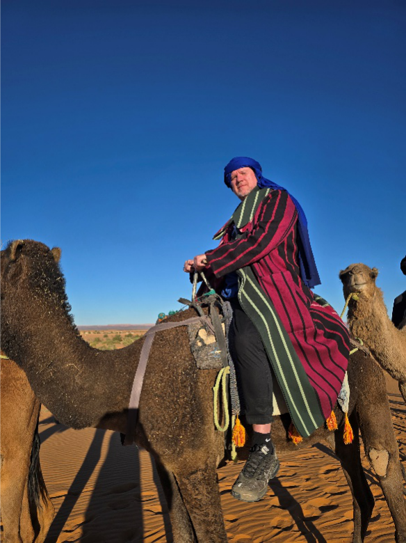 A person riding a camel