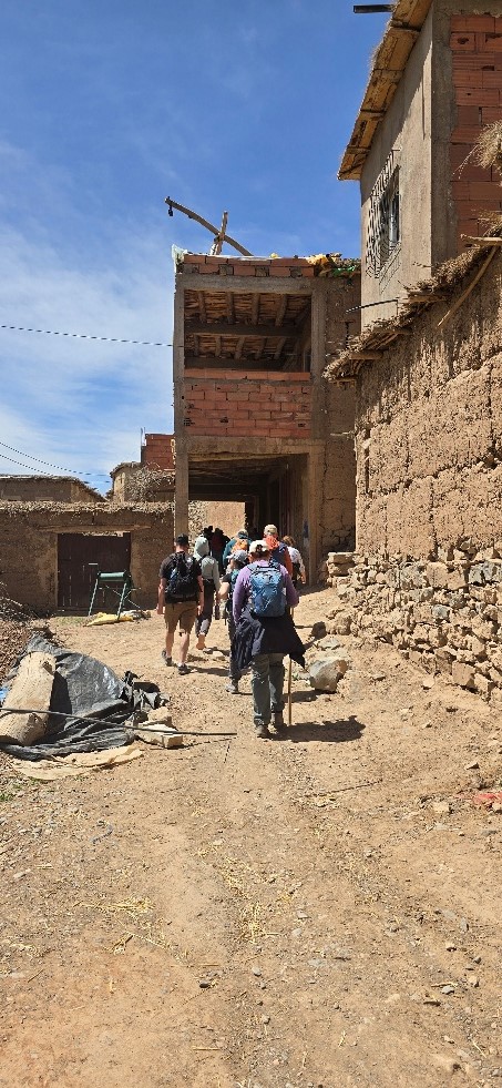 People walking through a sandy path