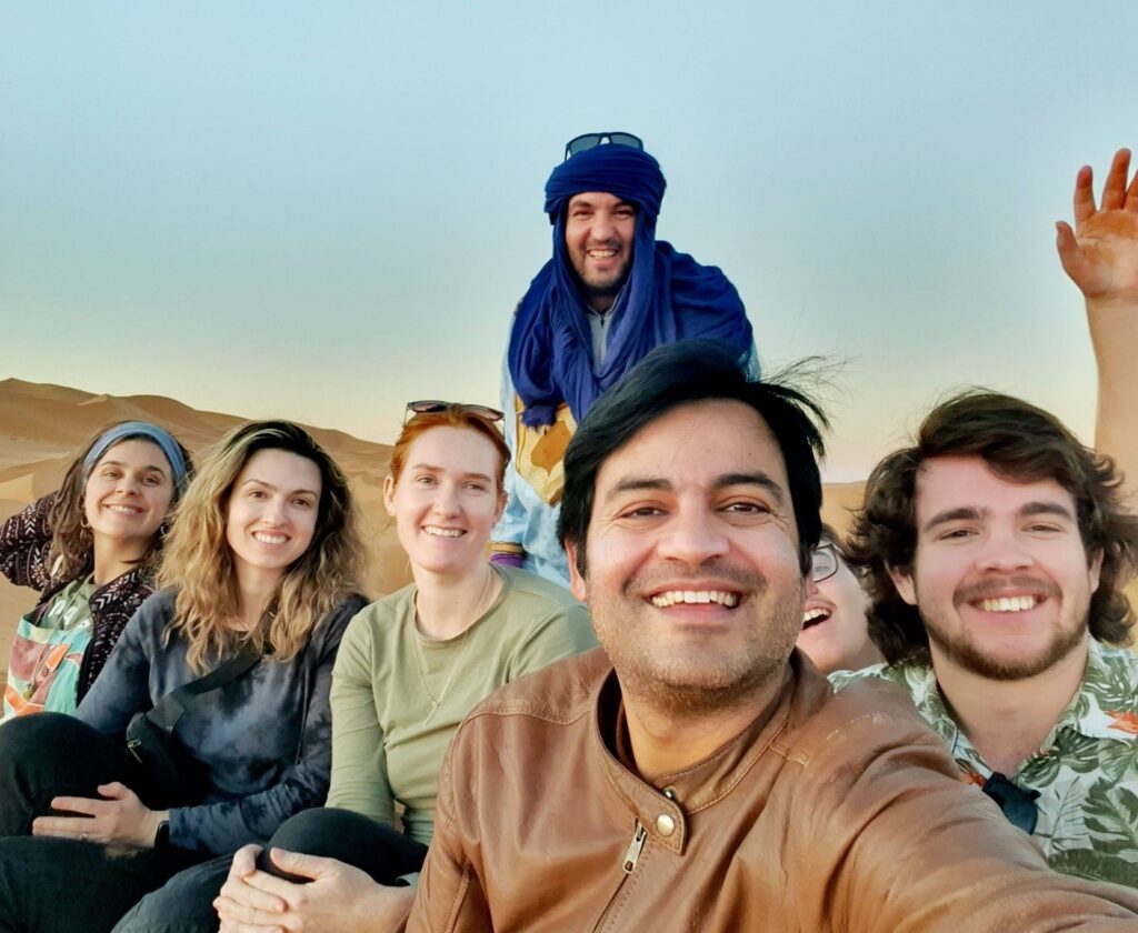 A group of tourists posing in a desert