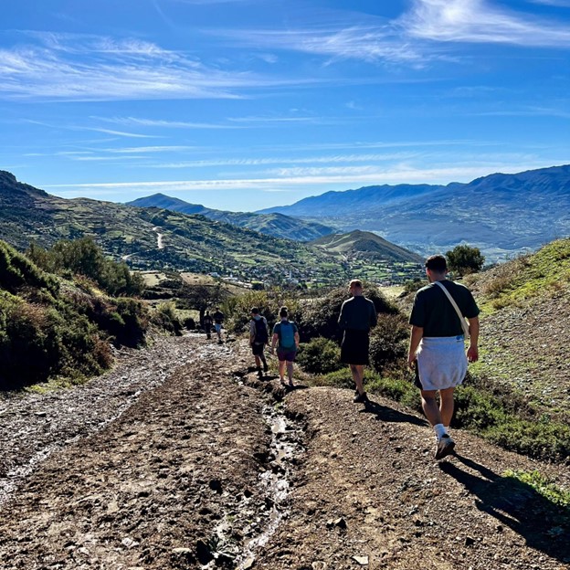 People walking down a mountain path