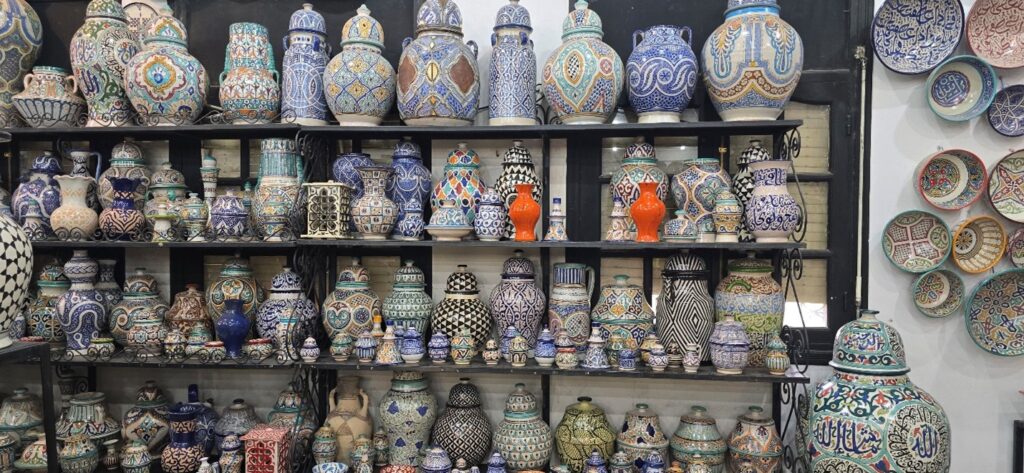 A shelf full of patterned vases