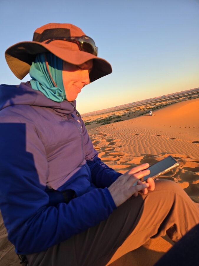  A woman sitting on desert sand