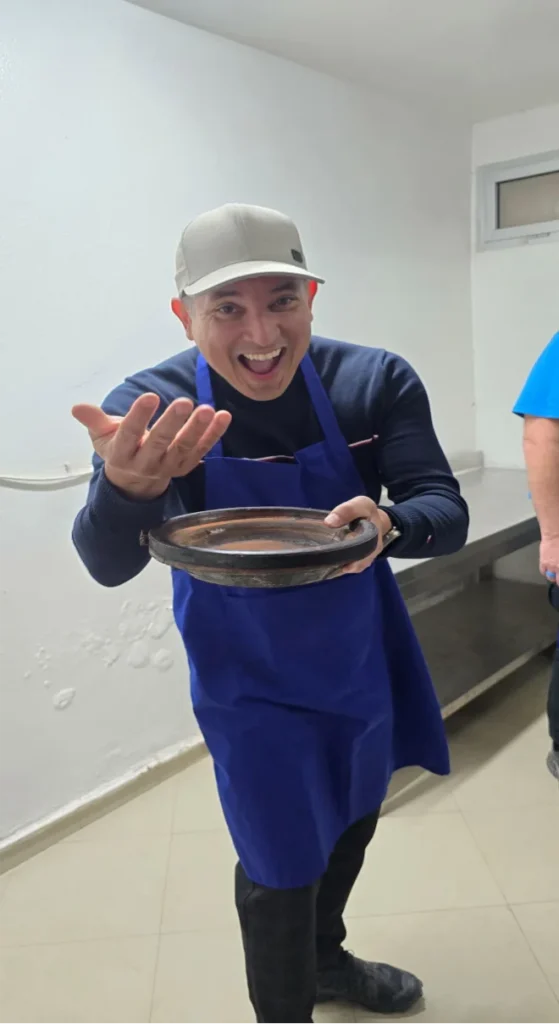 A man smiling with a plate of food