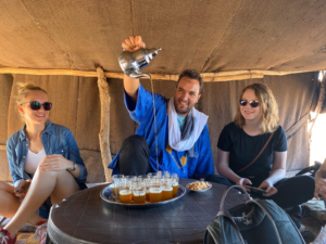 Omar, a Berber native, carefully pouring traditional Moroccan mint tea.